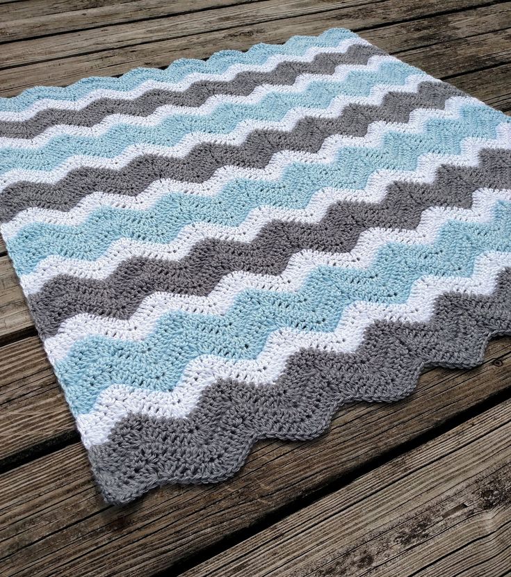 a crocheted blanket sitting on top of a wooden table