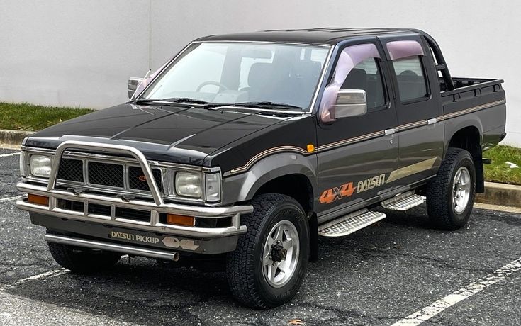 a black pick up truck parked in a parking lot