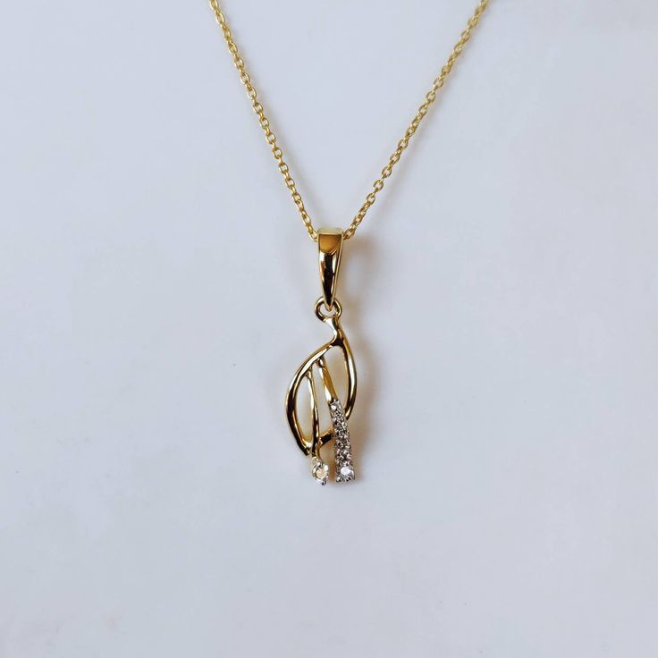 This is an exquisite diamond pendant set in 14K Solid Gold. An elegant design, perfect for regular wear featuring close set sparkling diamonds. ITEM DETAILS: ✓ Gold Kt: 14K Yellow Gold ✓ Gold Weight: 0.87 grams ✓ Pendant Size: 15x6mm ✓ Diamond Shape/ Cut: Round Brilliant ✓ Diamond weight: 0.05 carats ✓ Diamond No.: 7 Natural Diamonds ✓ Diamond Color: I-J ✓ Diamond Clarity: SI >>The Gold purity is guaranteed and it comes with authentic 14K gold hallmark. >>Jewlery Report provided as well certifie Necklaces With Diamond Accents In Cubic Zirconia, American Diamond Necklaces With Diamond Accents, Diamond White American Diamond Necklace, Diamond White Hand Set Diamond Necklace Gift, Gold Diamond Solitaire Teardrop Pendant Necklace, Gold Diamond Solitaire Necklace With Teardrop Pendant, Cubic Zirconia Diamond Pendant Necklace Hand Set, Elegant Diamond Pendant Necklaces, Hand Set Cubic Zirconia Diamond Pendant Necklace