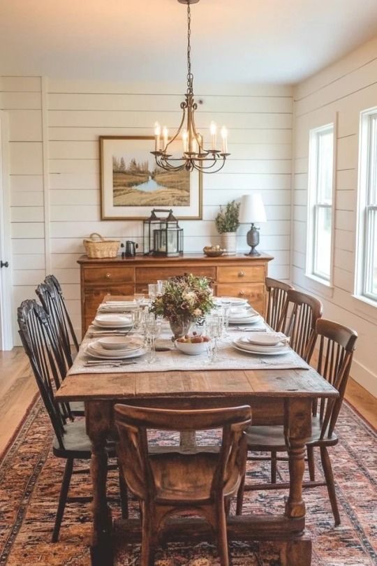 the dining room table is set with place settings