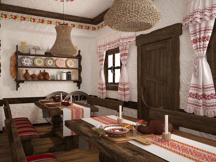 an old fashioned dining room is decorated with red and white table cloths, wooden chairs, and hanging lights