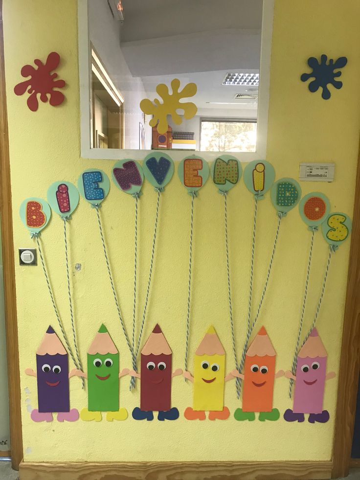 a bulletin board decorated with crayons and pencils on the front door for kids to use