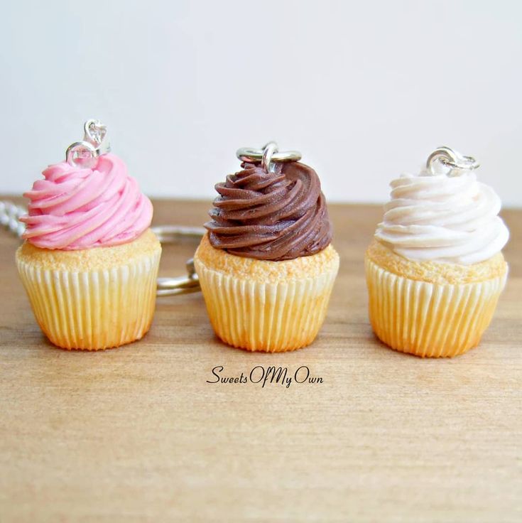 three cupcakes with different colored frosting on them