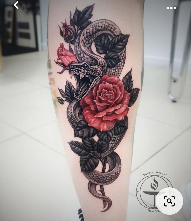 a snake and rose tattoo on the leg