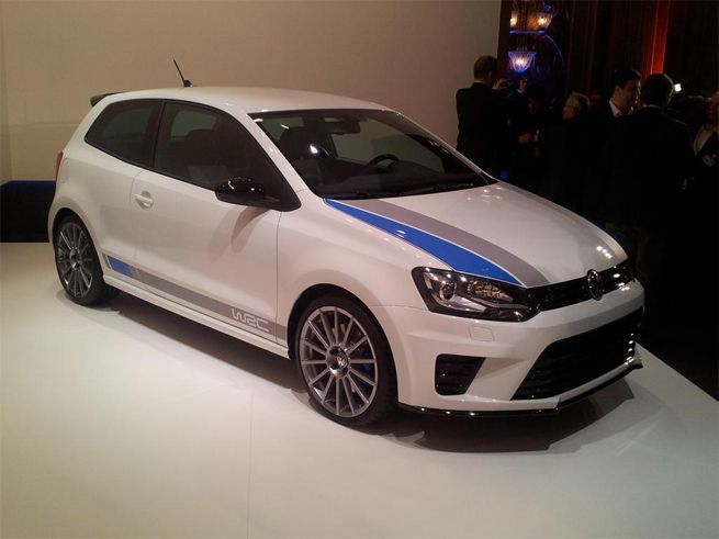 a white and blue car on display at an auto show