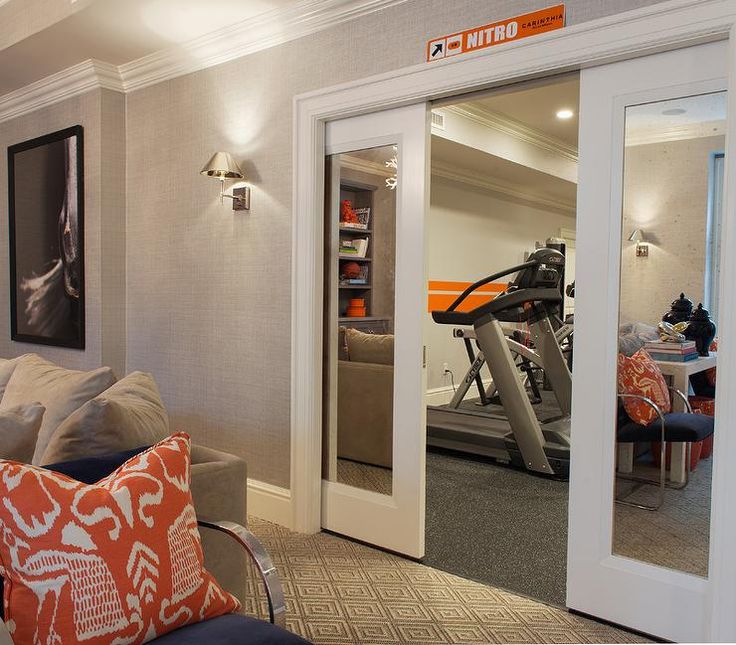 a living room filled with furniture and a gym