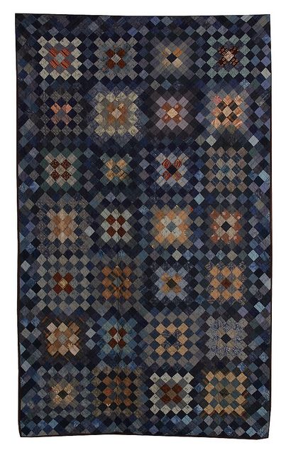 a blue and brown rug with many squares on the front, in different sizes and colors