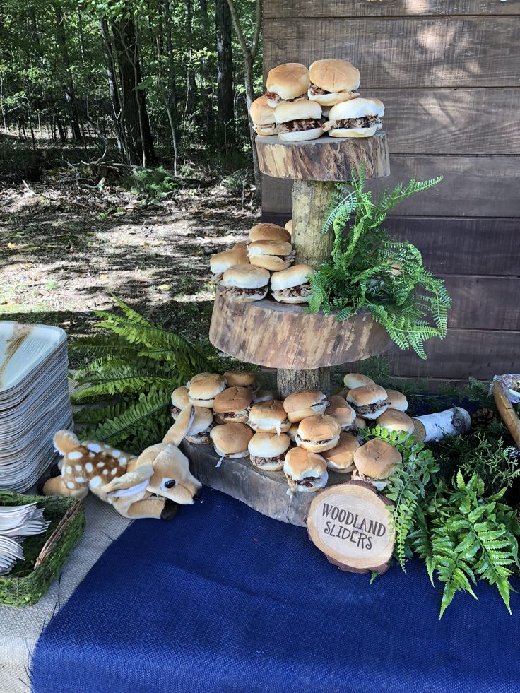 there is a cake made out of wood and mushrooms on the table in the woods