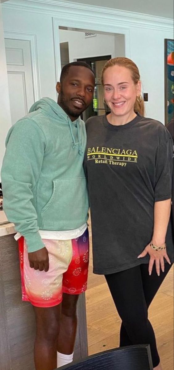 the man and woman are posing for a photo in front of their kitchen counter top