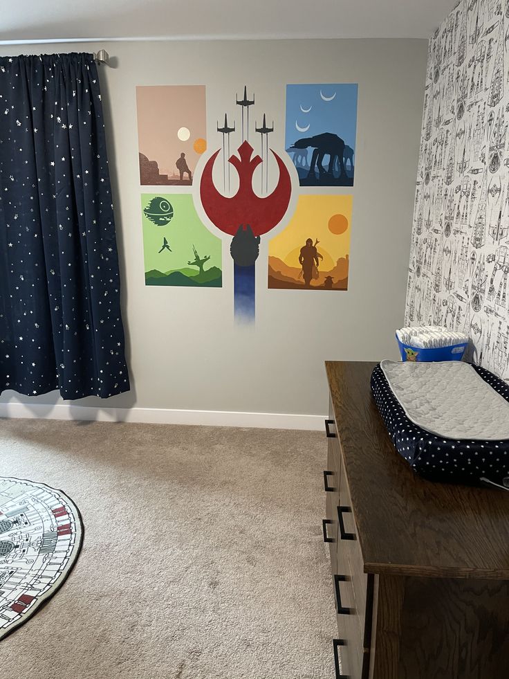 a baby's room with posters on the wall and a crib next to it