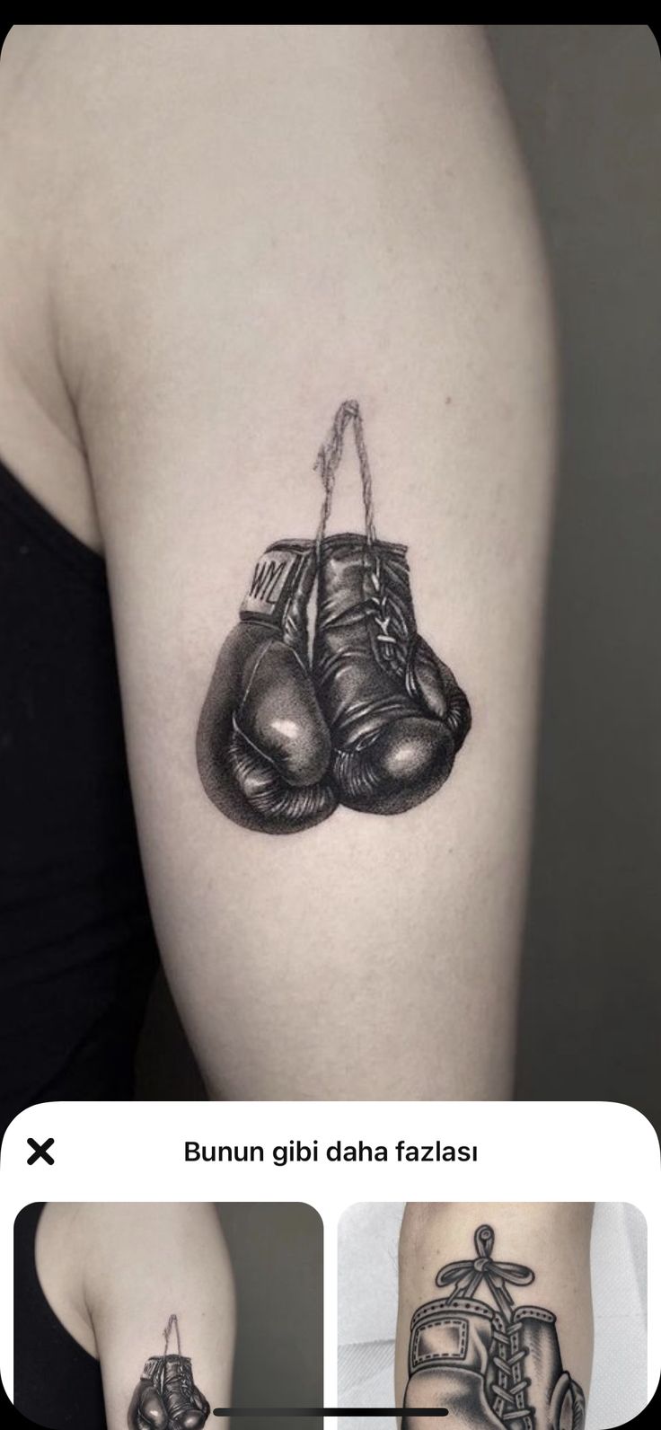 an arm tattoo with two boxing gloves on it