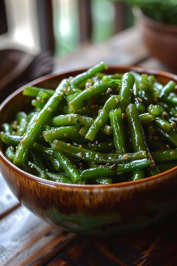 Green beans seasoned with sesame seeds in a wooden bowl. Green Beans Vegetarian Recipe, Tasty Green Beans Recipe, Different Ways To Make Green Beans, Perfect Green Beans, Best Way To Cook Canned Green Beans, Dark Green Vegetables Recipes, Easy Frozen Green Bean Recipes, Greenbean Side Dish Recipes, Best Frozen Green Bean Recipe