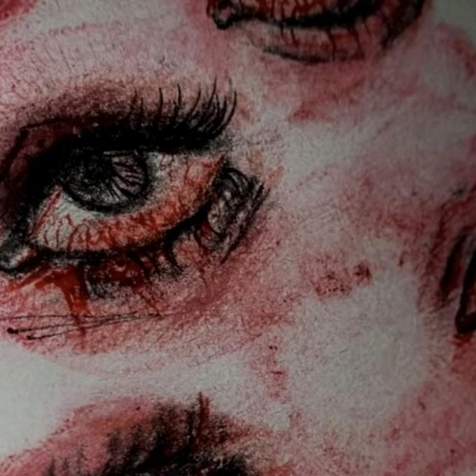 an artistic drawing of two eyes with blood on them