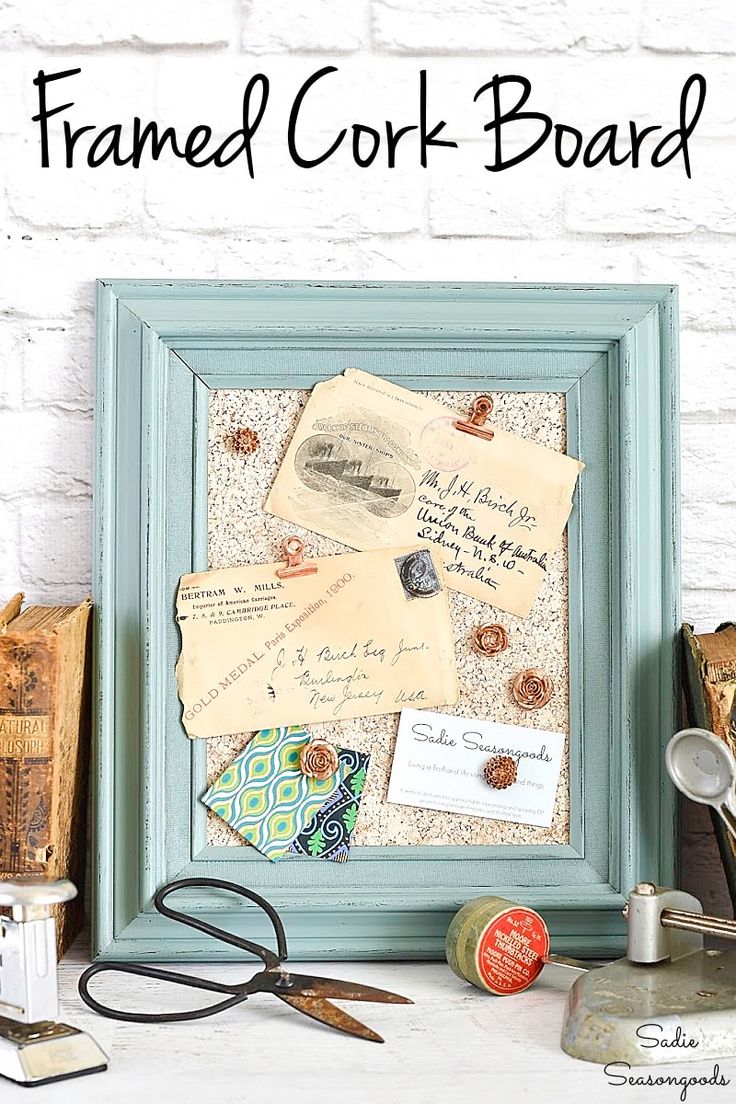 framed cork board with old papers and scissors on the table next to some other items