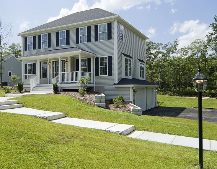 a two story house with steps leading up to the front door