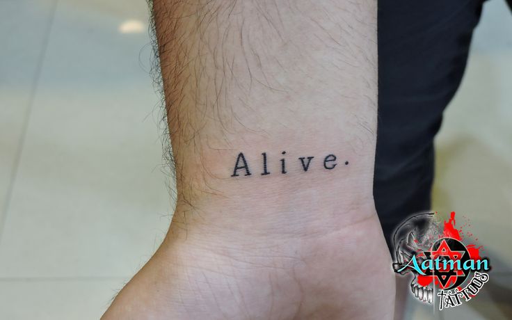 a man's wrist with the word alive tattooed on his left arm and an inscription below it that reads alive