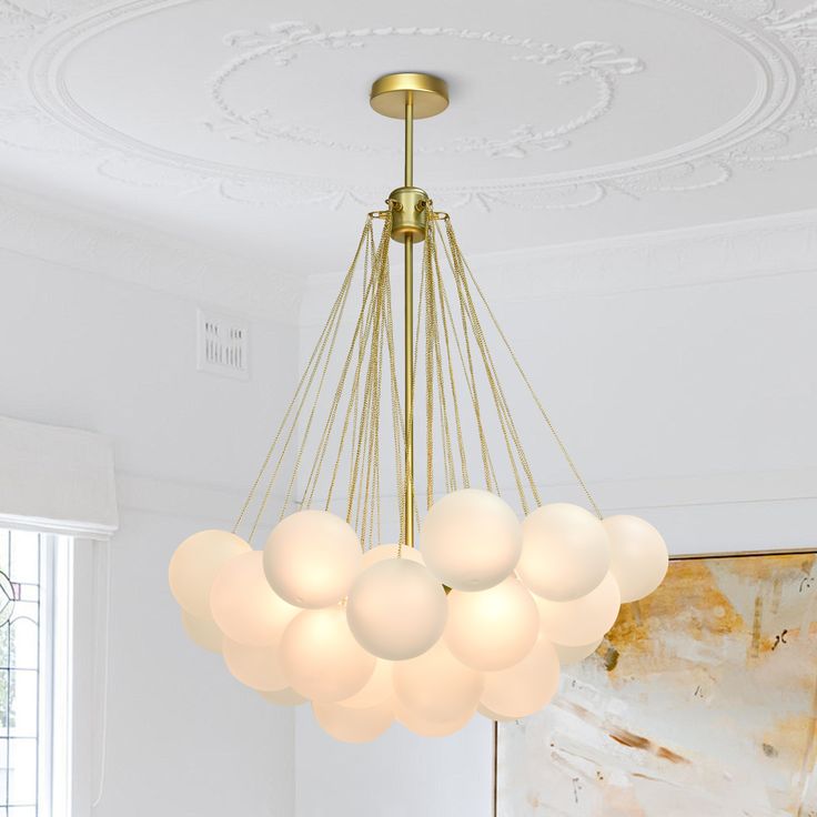 a chandelier hanging from the ceiling in a living room