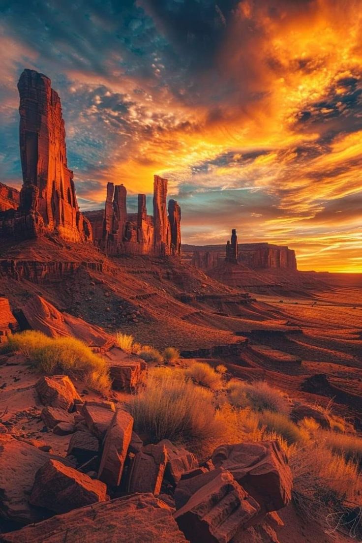 the sun is setting over some rocks in the desert