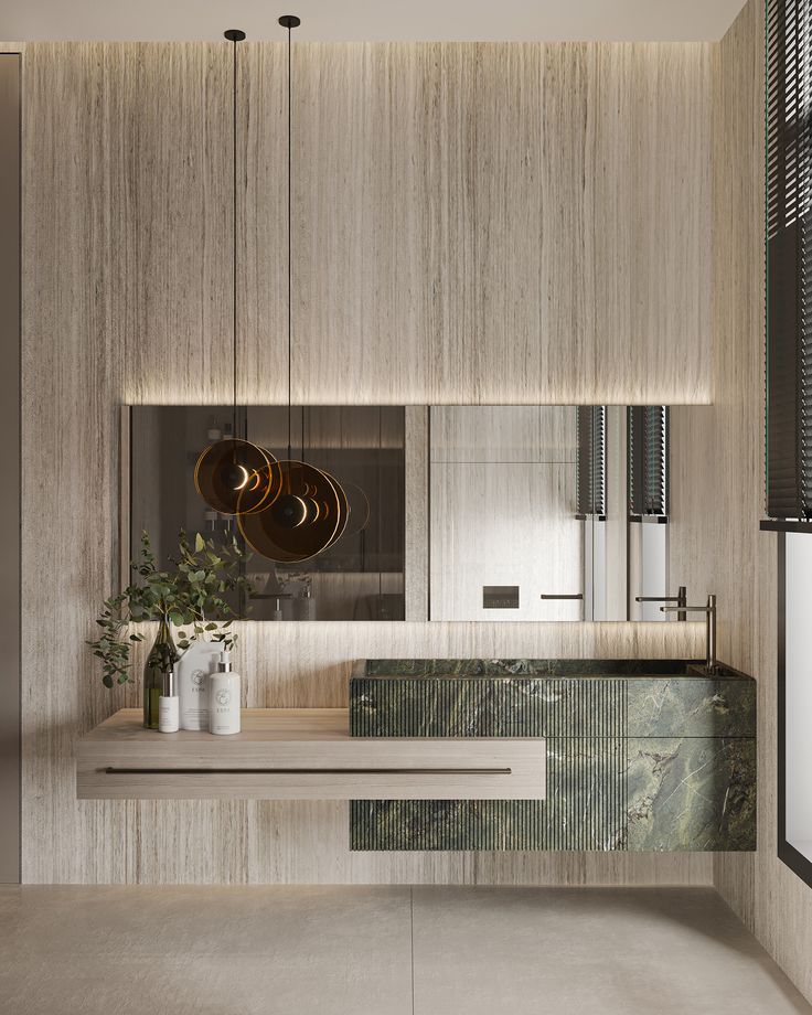 a modern bathroom with marble counter tops and wooden cabinets, along with hanging lights above the sink