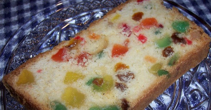 a piece of cake with gummy bears on it sitting on a glass platter