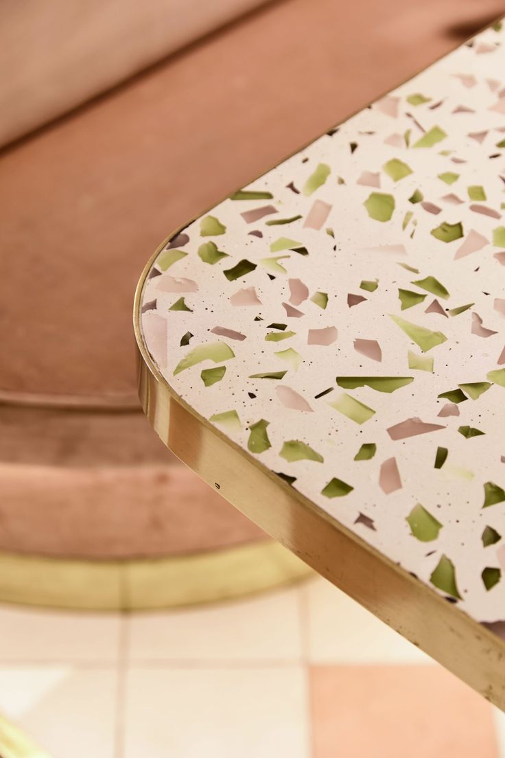 a close up view of a table with some paper on it and a chair in the background