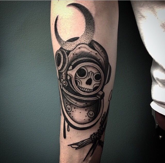 a man's arm with a tattoo on it and a skull in a space suit