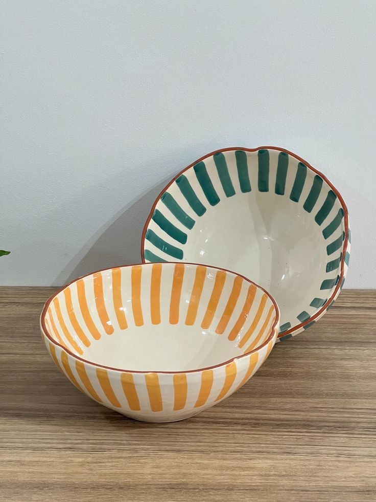 two bowls sitting on top of a wooden table