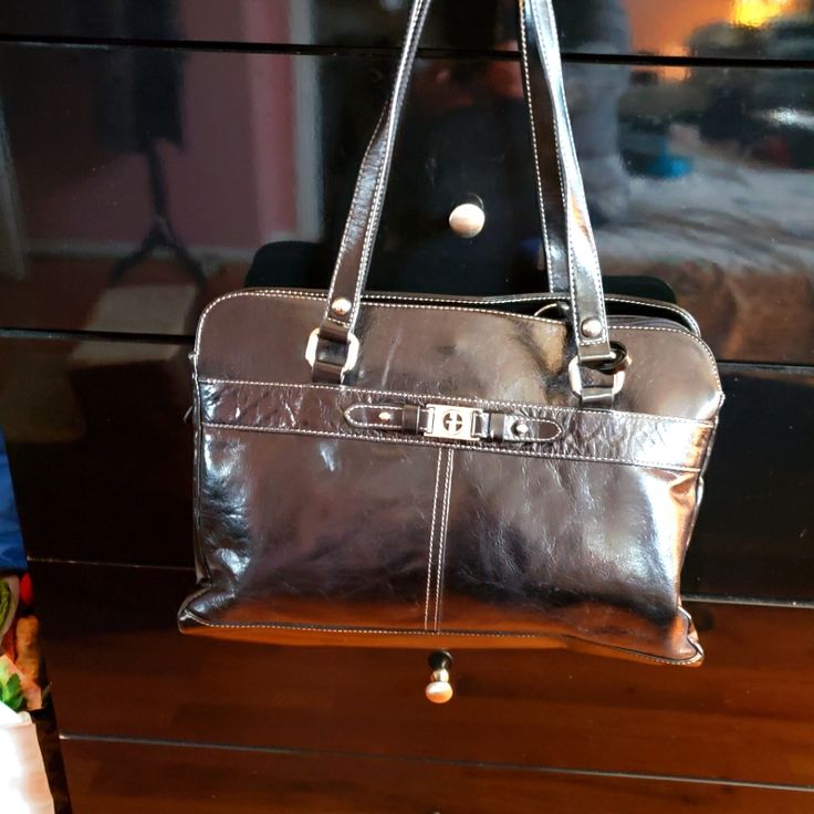 This Handbag Is By Giani Bernini It Has Plenty Pockets Very Spacious For All Your Necessity. The Handbag Is Nwot Never Has Been Used. Top Of Handle To The Top Of The Bag Is 11.5" Actual Strap Is 14.25"..... Handheld Shoulder Bag With Silver-tone Hardware For Travel, Travel Handheld Shoulder Bag With Silver-tone Hardware, Silver Satchel Shoulder Bag With Top Carry Handle, Office Satchel Bag With Silver-tone Hardware, Silver Leather Bag For Office, Silver Leather Office Bag, Office Satchel With Silver-tone Hardware, Silver Top Handle Office Bag, Silver Bags For Everyday Use