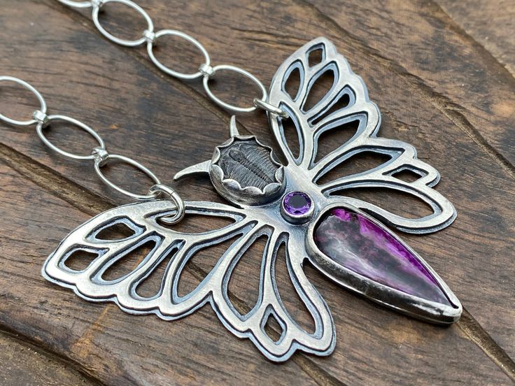 Purple Butterfly Necklace. Artisan Sterling Silver, Trilobite, Sugilite, Amethyst. Raw, Primitive, Organic, Tribal, Moth, Boho, Fossil. This Purple Butterfly Pendant was made with love by yours truly - as part of my Purple Nebula collection - with sterling silver, fine silver, purple South African sugilite cabochon cut by talented lapidary artists from the nice Etsy store called ColoradoGemworks out of Boulder, CO, a baby Trilobite fossil from the nice Etsy store called ArtifactsandFossils out o Unique Hand Forged Purple Necklaces, Artistic Handmade Purple Jewelry, Spiritual Purple Jewelry With Unique Variations, Purple Hand Forged Spiritual Jewelry, Artistic Purple Pendant Jewelry, Collectible Spiritual Purple Necklace, Purple Soldered Pendant Jewelry, Hand Forged Purple Spiritual Jewelry, Soldered Purple Pendant Jewelry