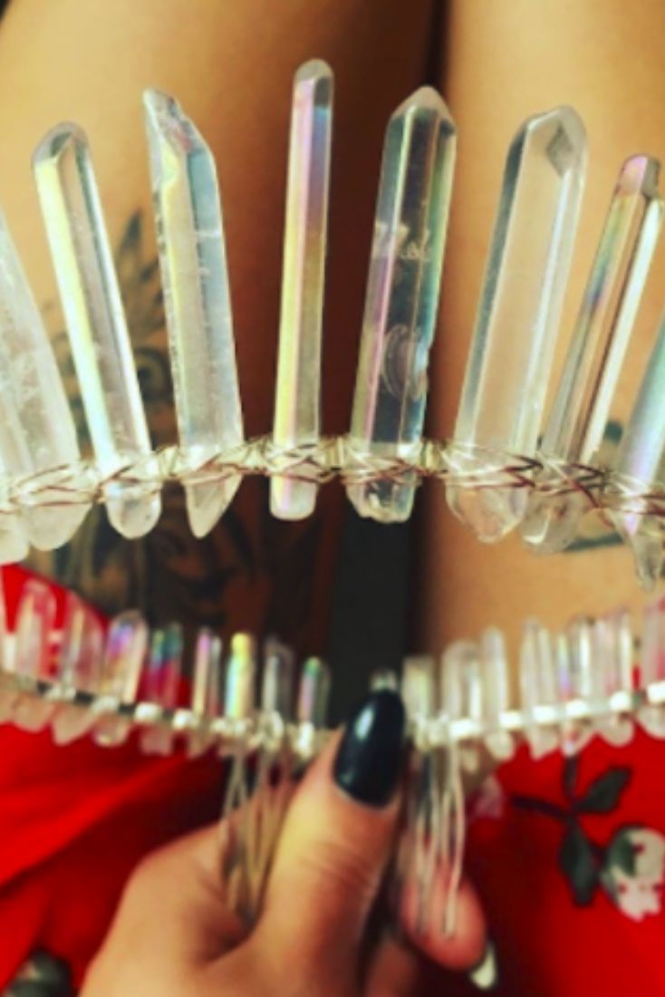 the woman is holding several clear glass objects in her hands and showing off her tattoos