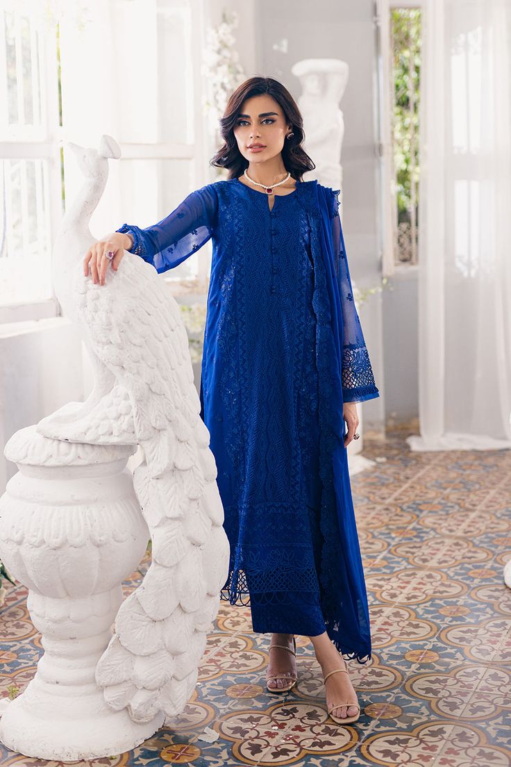 Luxury Navy Blue Embroidered Pakistani Salwar Kameez in Chiffon comes with sequin-Embroidered Chiffon, chic cutwork, raw silk bottoms, and embroidered dupatta exudes elegance. Chiffon Kameez: Pakistani Embroidered Salwar Kameez Chiffon is emblazoned with lavish floral designs, motifs, and delicate embroidery. Beaming sequins and threads make this beautiful kameez in an alluring blue color a perfect choice to wear for the festive occasion. Raw Silk Trousers: Embroidered kameez is paired with trousers to create a magnificent Pakistani Salwar Kameez. The trousers are in raw silk fabric and their borders are emblazoned with embroidery and lace work. Chiffon Dupatta: Pakistani Salwar Kameez achieves the final ravishing look when paired with a delicate chiffon dupatta. Embroidered scalloped bord Pakistani Salwar, Raw Silk Fabric, Organza Sleeves, Pakistani Salwar Kameez, Silk Bottoms, Embroidered Chiffon, Dresses Chiffon, Embroidered Dupatta, Formal Outfits