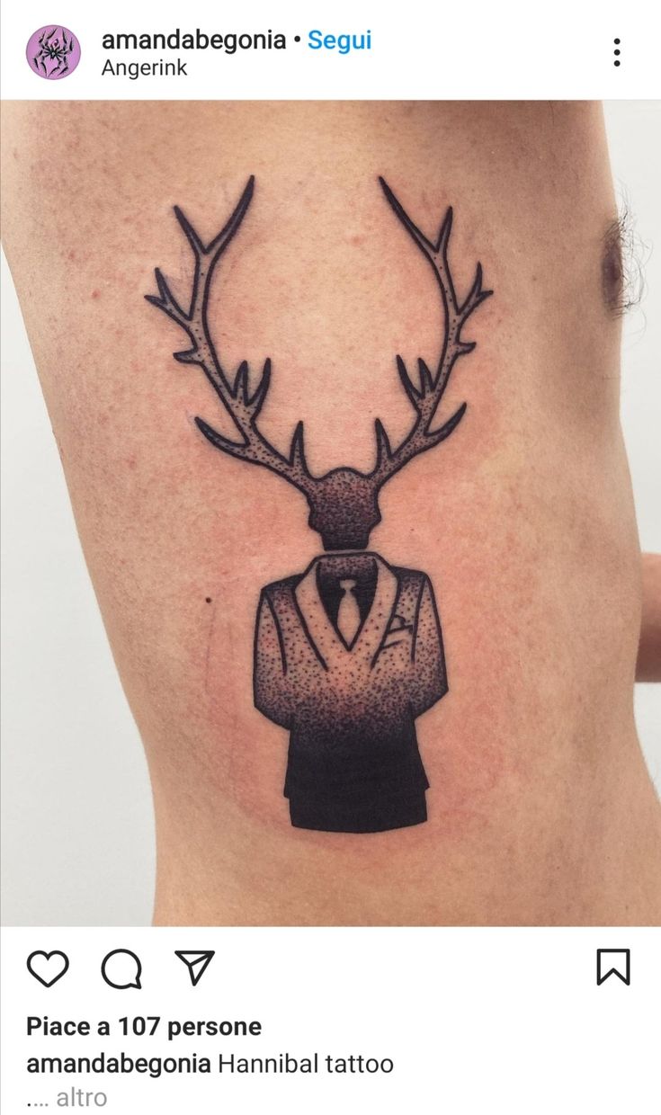 a tattoo with a deer's head wearing a suit and tie on the ribs