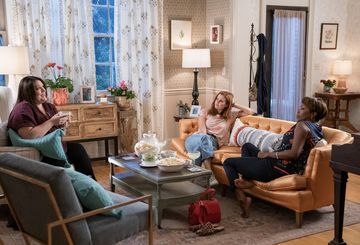 three women sitting on couches in a living room