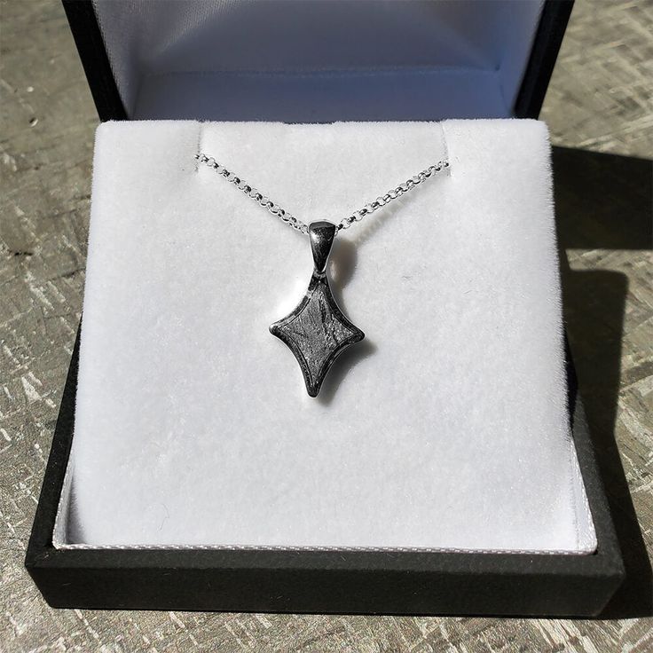 Get them a gift that is out of this world. Show them your love shines brighter than a star in the night sky. This meteorite star necklace in sterling silver will make the perfect gift for anyone who wants to add a cosmic twist to their attire. DETAILS OF THE PENDANT Metal: Sterling Silver Size: 16 mm x 12 mm Thickness: 3 mm Bail Size: 3 mm x 7 mm DETAILS OF THE CHAINMetal: Sterling SilverLength: 18″Width: 1.5 mmClasp: Spring Ring Sterling Silver Necklace With Star Charm For Gifting, Sterling Silver Necklace With Star Charm As Gift, Sparkling Celestial Sterling Silver Jewelry, Sterling Silver Sparkling Pendant Necklace, Gift Sterling Silver Necklace With Star Charm, White Gold Necklace With Star Charm As Gift, Gift White Gold Necklace With Star Charm, Star-shaped Sparkling Sterling Silver Necklace, Sterling Silver Star Necklace With Sparkling Details