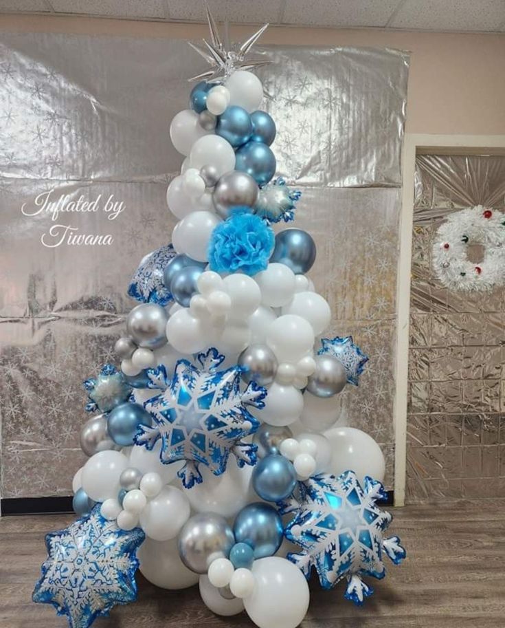 a christmas tree made out of balloons and snowflakes