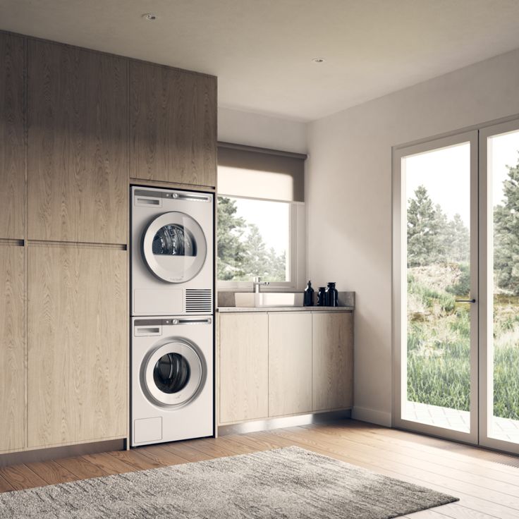 a washer and dryer in a room with wood flooring on the walls