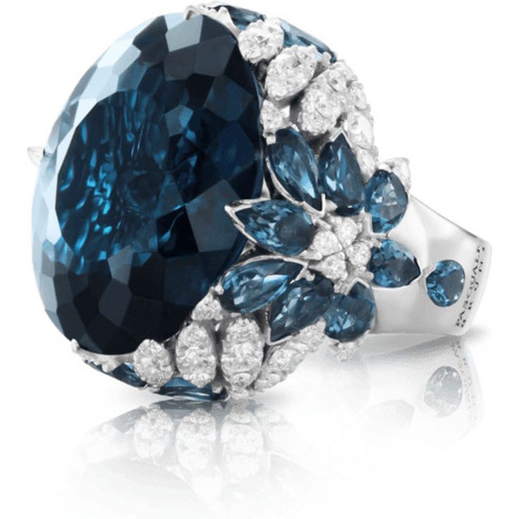 Indulge in pure luxury with the 18k White Gold Ghirlanda Couture Ring from Pasquale Bruni. This exquisite piece features a breathtaking London Blue Topaz gemstone that sparkles in the light, surrounded by a halo of diamonds that perfectly complement its blue hues. The ring's intricate design is reminiscent of delicate garlands, creating a truly unique and timeless piece that exudes elegance and sophistication.Crafted from the finest 18k white gold, this ring is a true masterpiece of Italian craftsmanship, with every detail thoughtfully considered to create a piece that is both stunning and durable. The Ghirlanda Couture Ring is a perfect choice for any occasion, whether you're looking to add a touch of glamour to your everyday look, or to make a bold statement at a special event.With its t Pasquale Bruni, Diamond Birthstone, Jewelry Appraisal, London Blue Topaz, Topaz Gemstone, London Blue, Diamond Wedding Rings, White Gold Rings, Cocktail Rings