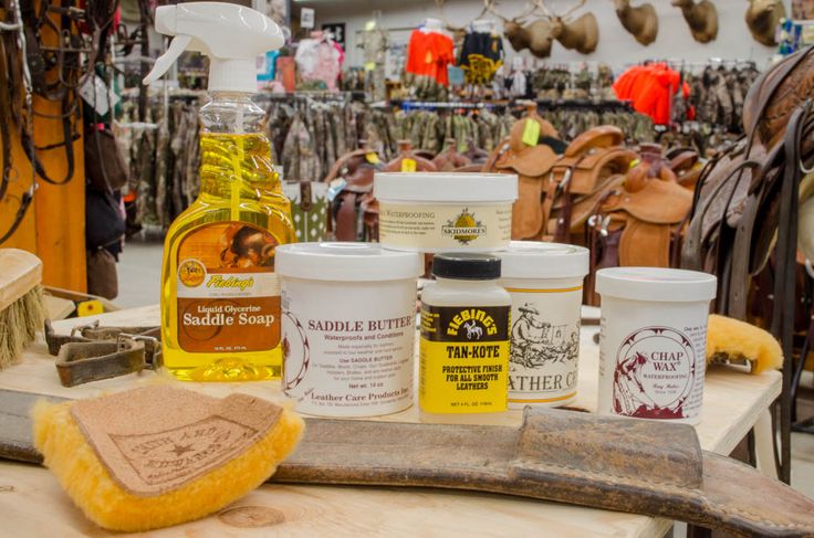 several different types of leather products on a table in a shoe shop, with one being used as a cleaner