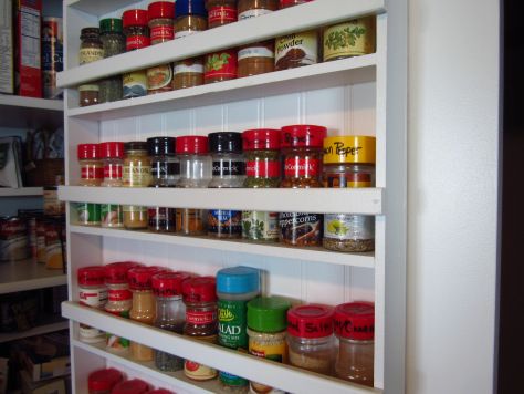 the shelves are full of spices and jars