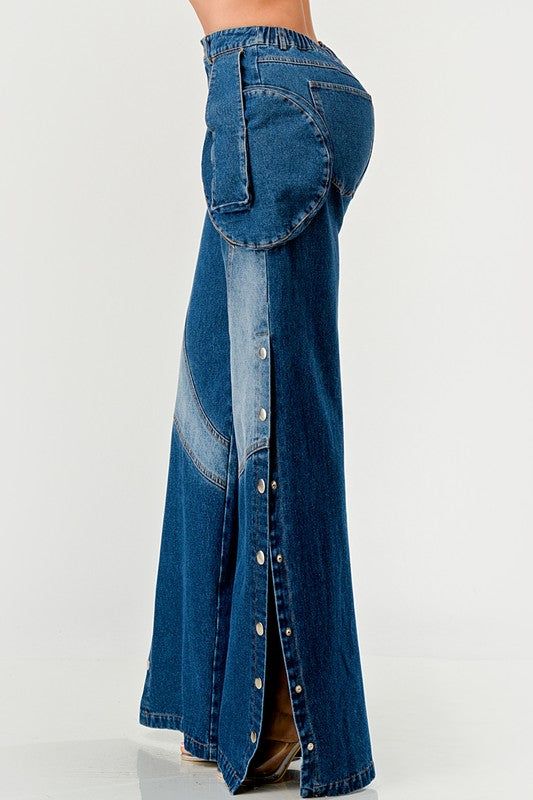 Indigo Trail Denim PantsThe design features a high-waisted, wide-leg silhouette that offers a bold statement with its unique buttoned side splits and contrasting stitched accents. The palazzo pants are adorned with pronounced curved pockets that follow the hip line, incorporating zippers for a modern, utilitarian edge. Crafted from a rich indigo denim, these pants balance retro inspirations with contemporary fashion sensibilities, perfect for making a standout addition to a fashion-forward wardr Loungewear Dresses, Indigo Denim, Side Splits, Jumpsuit Fashion, Womens Clothing Stores, Palazzo Pants, Denim Pant, Contemporary Fashion, Retro Inspired