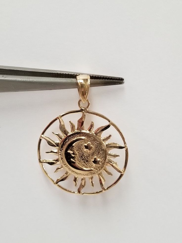 "Thanks for shopping our vintage estate store. We tend to sell well below wholesale and truly hope you enjoy all of our items. Many of the items are one of a kind, so please enjoy scrolling through the pictures and hopefully something will catch your eye. Brown spots are from the camera or reflections. Beautiful 14k yellow gold sun moon stars pendant. Length: 1 1/8\" with bail Width: 1\" Thickness: 1.2mm 1/16\" Weight: 2.10 grams Bail: 2.5mm Marked 14k, as all our gold is marked and tested to be Celestial Engraved Jewelry For Anniversary, Celestial Round Pendant Jewelry With Hallmark, Anniversary Crescent Jewelry Engraved, Collectible Celestial Sun And Moon Jewelry, Celestial Sun And Moon Collectible Jewelry, Collectible Round Pendant With Moon Charm, 14k Gold Celestial Sun And Moon Jewelry, 14k Gold Celestial Jewelry With Sun And Moon Design, Celestial Engraved 14k Gold Jewelry