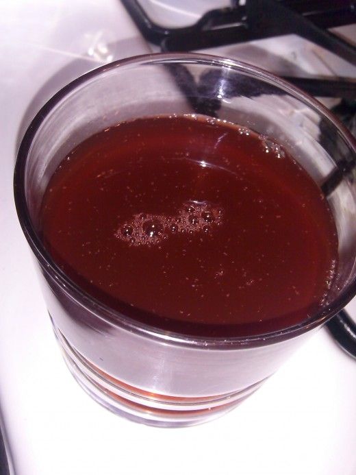 a glass cup filled with liquid sitting on top of a counter