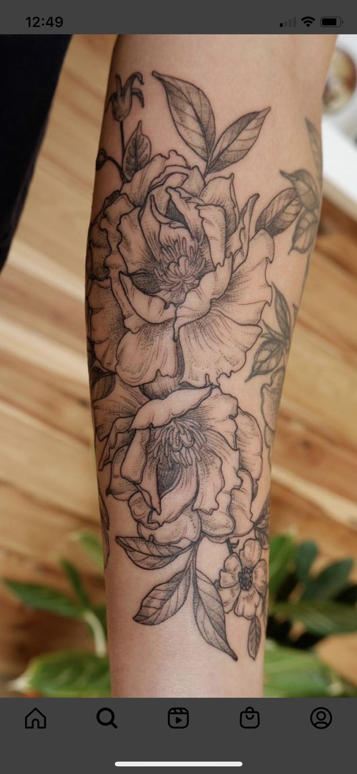 a woman's arm with flowers on it