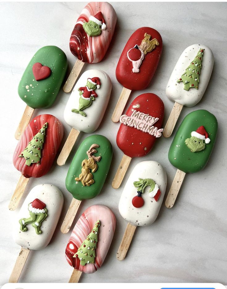 there are many christmas themed lollipops on the stick