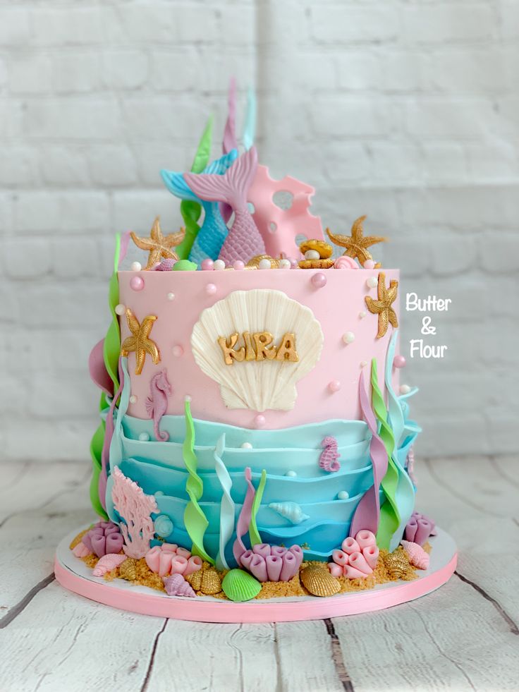 a pink and blue cake decorated with sea life