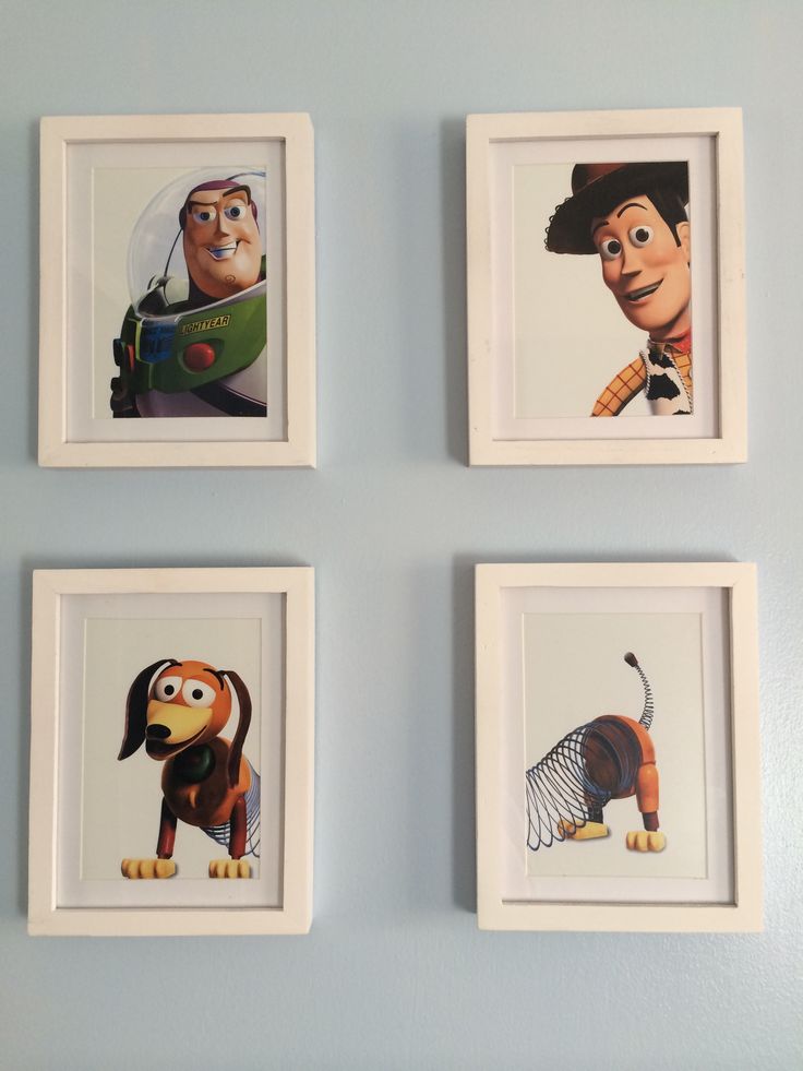 four framed pictures of cartoon characters on the wall in a room with blue walls and white trim