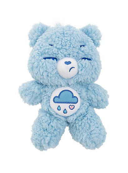 a blue teddy bear with eyes closed and a cloud on it's chest is shown