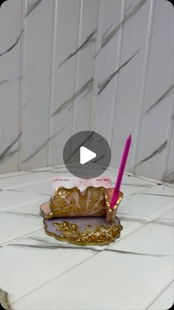 a pink pen sitting on top of a piece of cake