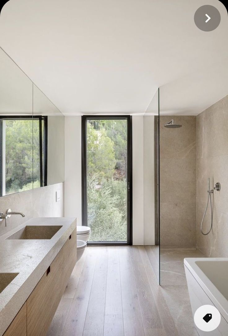 a large bathroom with two sinks and a bathtub next to a walk in shower