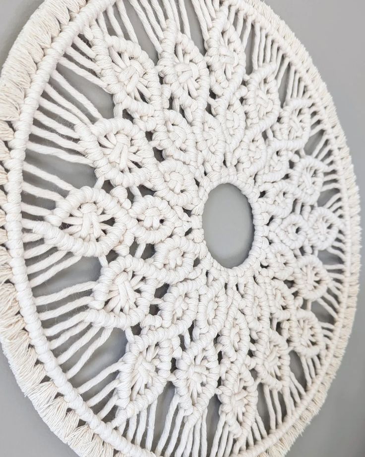 a white doily hanging on the wall